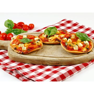 Pizzetas de tomate, queso de cabra y pesto